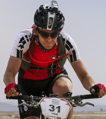 Homme pédalant à vélo en extérieur sur une route pendant une course